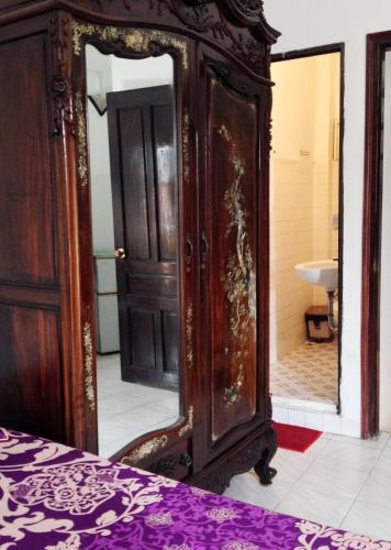 a bedroom with a large mirror and a bed at North Hostel N.2 in Hanoi
