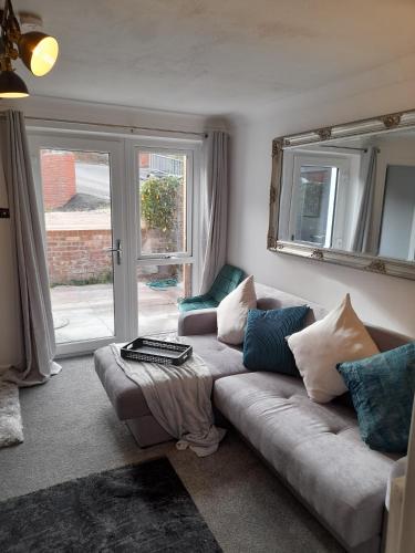 a living room with a couch and a window at 93 Newtown Road in Great Malvern