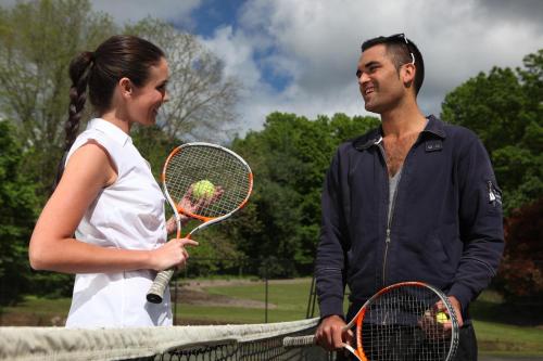 a man and a woman holding tennis rackets at Peppers Craigieburn Resort in Bowral