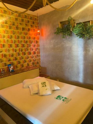 a table in a restaurant with a brick wall at Hotel & Motel ap Aparecida de Goiânia in Aparecida de Goiania