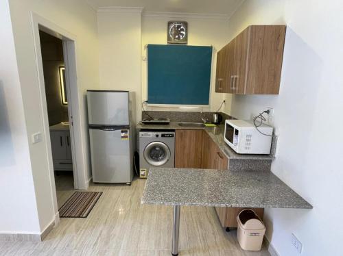 una piccola cucina con frigorifero e microonde di Dahab Residence a Dahab