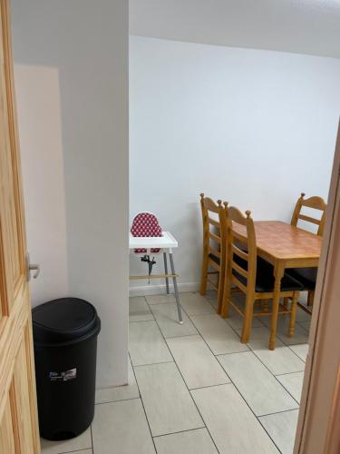 a dining room with a table and chairs and a trash can at Travel Legend Stays 1 or 2 bedroom place with Hot Tub in Farnham Royal