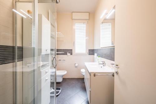 a bathroom with a toilet and a sink and a shower at La Casa di Edo - WiFi Parking free in Modena