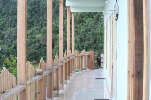a wooden walkway with a view of a mountain at Veda Inn in Chakrāta