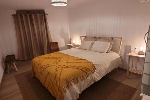 1 dormitorio con 1 cama con edredón amarillo en Casa Cereja, en Pêro Viseu