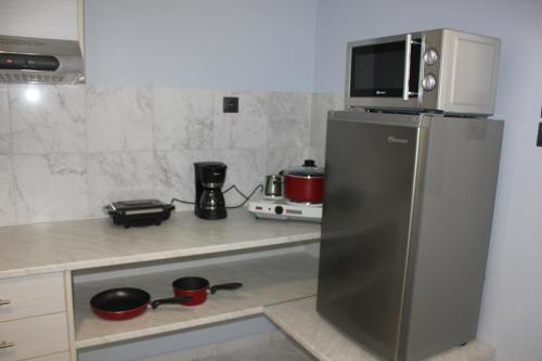 een keuken met een magnetron en een koelkast bij Modern house next to Metro station to explore Athens in Athene