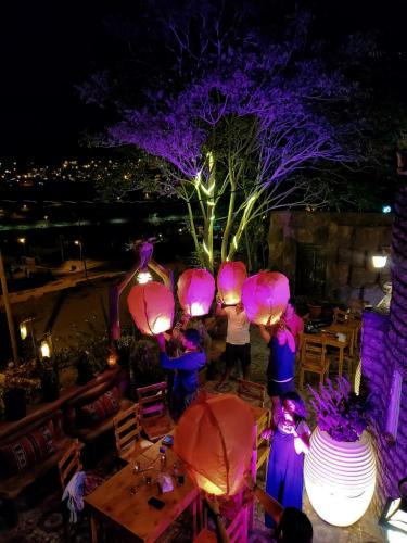 a group of people standing around a table with purple lights at Petra Desert Dream Hotel in Wadi Musa