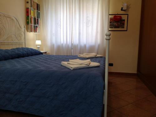 a bedroom with a blue bed with towels on it at Domus Cornelia in Naples