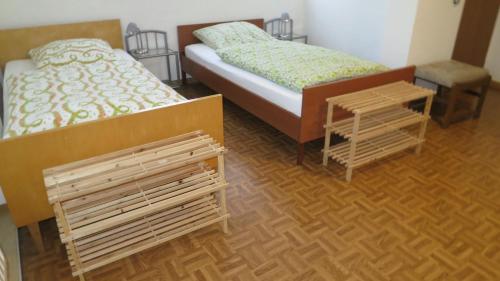 a bedroom with two twin beds and two tables at Alsfelder Apartment I in Alsfeld