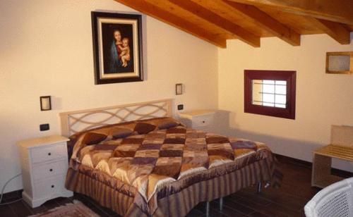 a bedroom with a large bed and a window at Agriturismo Al Navile in Malalbergo