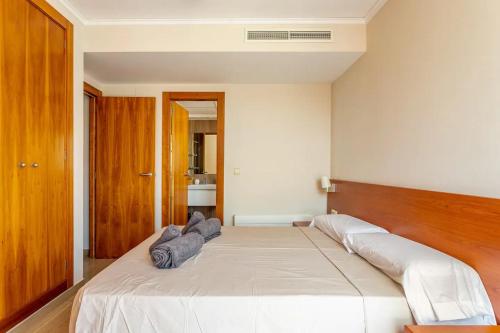 a bedroom with a large white bed with a wooden headboard at Paradero Rental B75 Vistas al Mar in Calpe