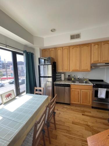 a kitchen with a table and a large window at The Fillmore Point Northern Liberties/Fishtown in Philadelphia