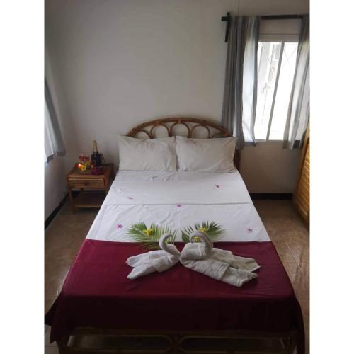 a bedroom with a bed with two towels on it at Villa Karel Mauritius Beach house in Riambel