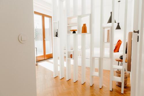 a living room with white walls and a staircase at JARS Apartments - Casa do Bessa in Porto