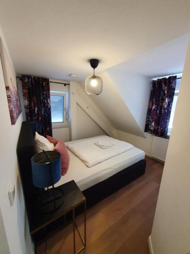 a small room with a bed and a table at ARGENTA Living 2 in Fulda