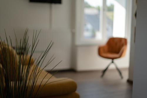 a living room with a couch and a chair at Rooms21 in Schiefling am See