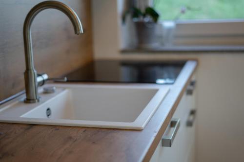 a kitchen sink with a faucet on a counter at Rooms21 in Schiefling am See