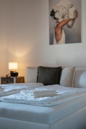 a bed with a towel on top of it at Rooms21 in Schiefling am See