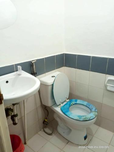 a bathroom with a toilet and a sink at 8 JOAQUIN'S Place WIFI Free! in Antipolo