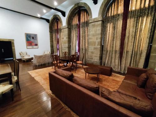 a living room with a couch and a table at Nap Palacio Marques de San Esteban in Figaredo
