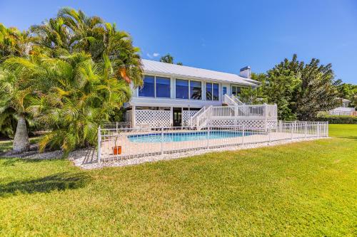 a house with a swimming pool in the yard at PEARL OF SANIBEL-Brand New to Rentals! in Sanibel