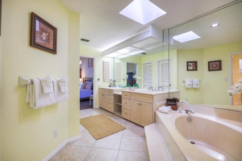 a large bathroom with a tub and a sink at PEARL OF SANIBEL-Brand New to Rentals! in Sanibel