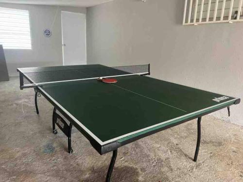 a green ping pong table in a room at Life Is Good in Fajardo