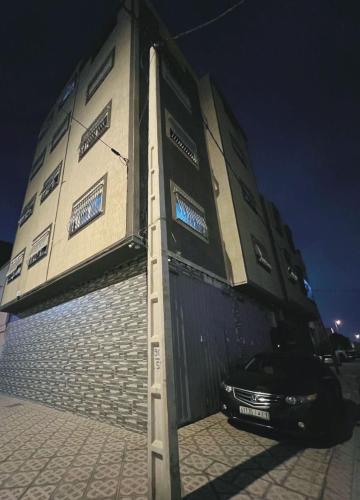 a car is parked in front of a building at Au dix sept in Dakhla