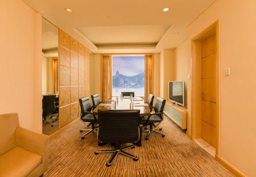 a conference room with a table and chairs and a window at Harbour Plaza Metropolis in Hong Kong