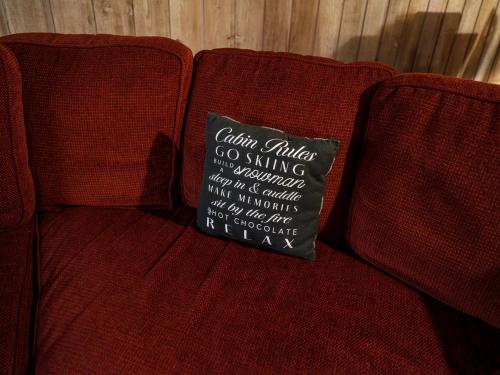 a chalkboard sign sitting on the back of a red couch at COZY Condo at Canyon Lodge! Sleeps 8, a walk to Canyon Lodge in Mammoth Lakes