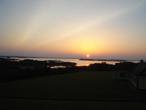 a sunset from the roof of a house at Tullaleagan Guesthouse in Oughterard