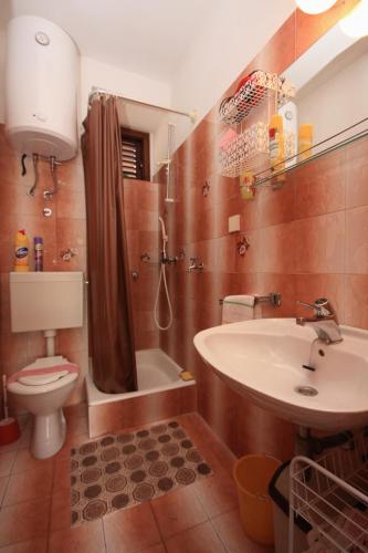 a bathroom with a toilet and a sink and a shower at Apartments by the sea Milna, Brac - 5242 in Milna