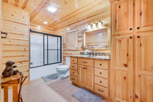 a log cabin bathroom with a toilet and a sink at Large Cabin with views of Beautiful NC Mountains in Murphy