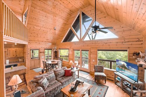 a living room with a vaulted ceiling with a large window at Large Cabin with views of Beautiful NC Mountains in Murphy