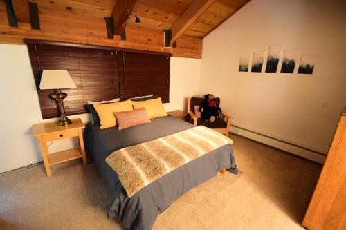 a bedroom with a large bed and a wooden wall at COZY Condo at Canyon Lodge! Sleeps 8, a walk to Canyon Lodge in Mammoth Lakes