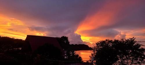 a sunset over a body of water with a rainbow at Drake Lapas in Drake