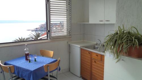 a kitchen with a table with a blue table cloth on it at Studio Igrane 5266b in Igrane