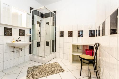 y baño con lavamanos, ducha y silla. en Family friendly apartments with a swimming pool Sveti Anton, Krk - 5291, en Malinska