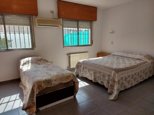 En eller flere senge i et værelse på Casa hermosa cómoda en barrio tranquilo