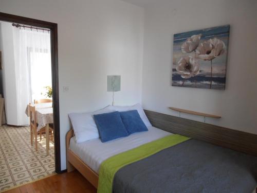 a bedroom with a bed with blue pillows at Apartments with a parking space Sveti Anton, Krk - 5288 in Sveti Anton