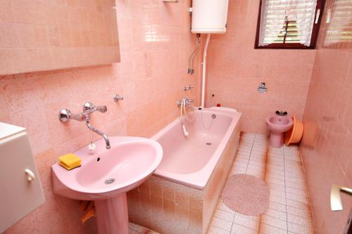 a bathroom with a sink and a tub and a toilet at Apartments with a parking space Malinska (Krk) - 5284 in Malinska
