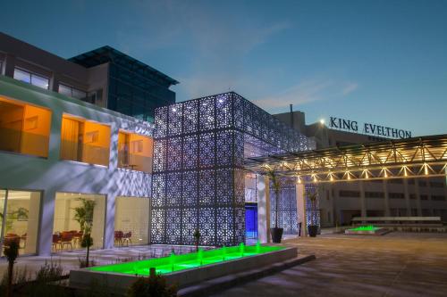 a building with a lit up facade with lights at King Evelthon Beach Hotel & Resort in Paphos