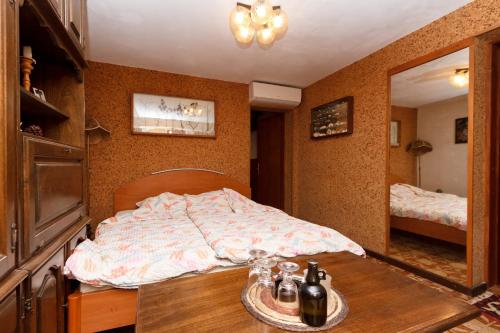 a bedroom with a bed and a table and a mirror at Apartment Malinska 5290b in Vantačići