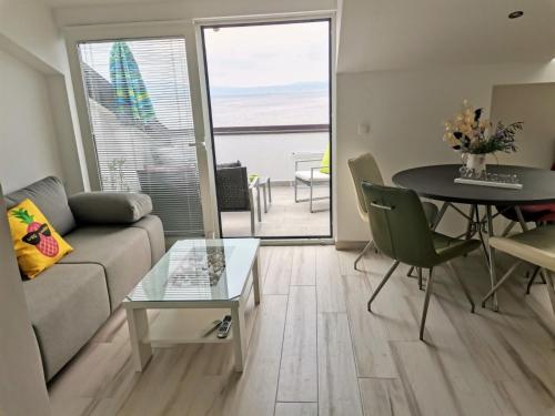 a living room with a couch and a table at Apartments by the sea Njivice, Krk - 5295 in Njivice