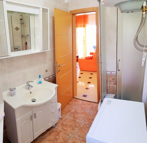 a bathroom with a sink and a toilet at Apartment Njivice 5295b in Njivice