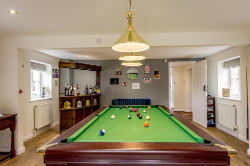 a living room with a pool table at Cottage In Norfolk Sleeps 23 - Private Pool, Fishing Lake, Hot Tub Ref 99008sc in Hockham