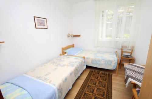 Postel nebo postele na pokoji v ubytování Apartment Krk 5318a