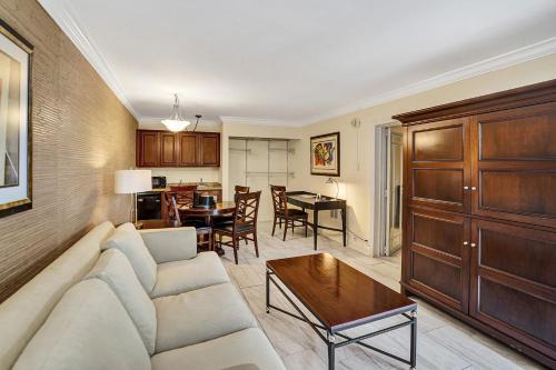 a living room with a couch and a table at Fort Lauderdale Grand Hotel in Fort Lauderdale