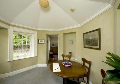 a dining room with a table and a window at Salterbridge Gatelodge in Cappoquin