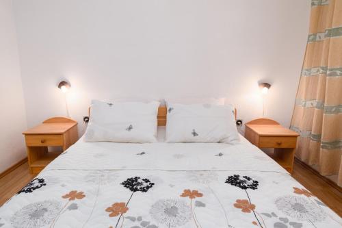 Apartment Punat 5351a في بونات: غرفة نوم مع سرير مع مواقف ليلتين